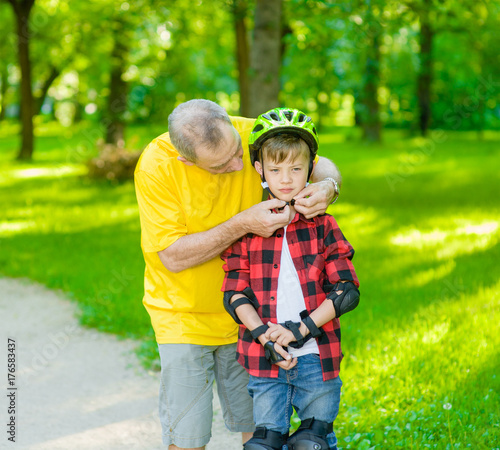 Father wears a bicycle helmet to his son