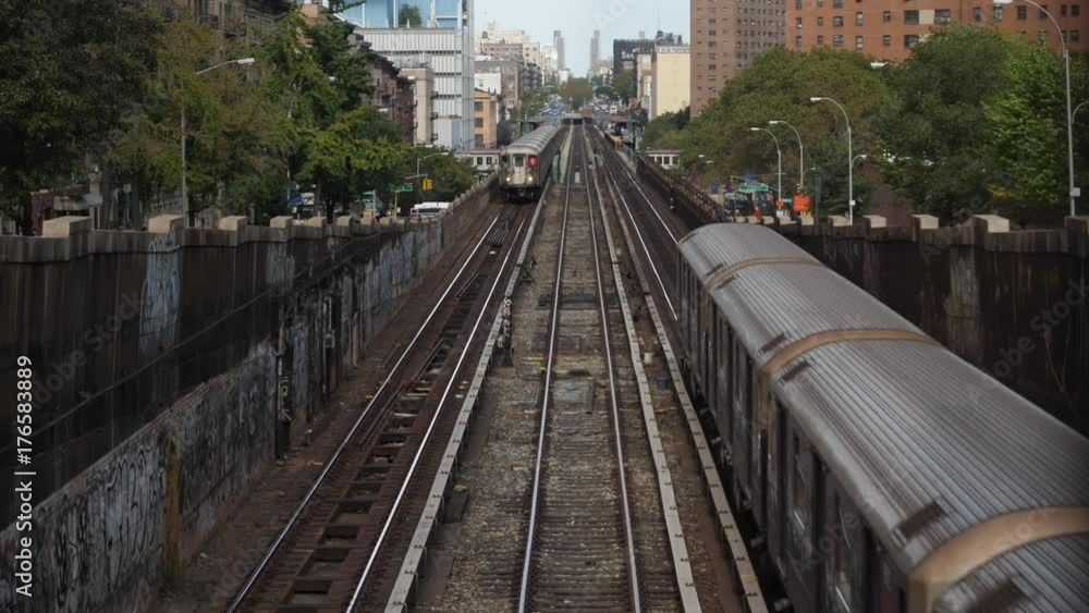 Two Harlem bound subway trains pass each other in upper Manhattan on an elevated track on Broadway on a summer day. Two Harlem bound subway trains pass each other in upper Manhattan on an elevated track on Broadway on a summer day.