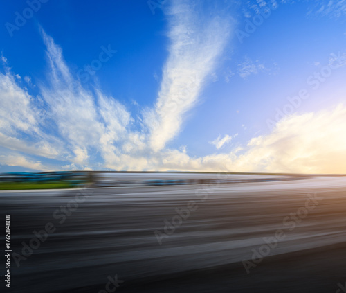 Motion blur asphalt road circuit and beautiful sky clouds at sunset