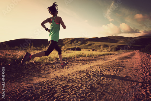 trail runner woman running on sunset forest © lzf