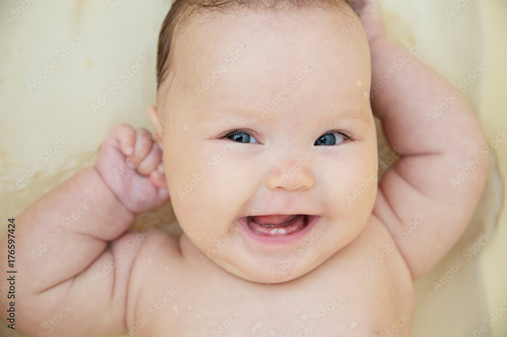 Happy smiling baby girl portrait in bath feeling good. Healthy lifestyle. Happy smiling baby girl portrait in bath feeling good. Healthy lifestyle.