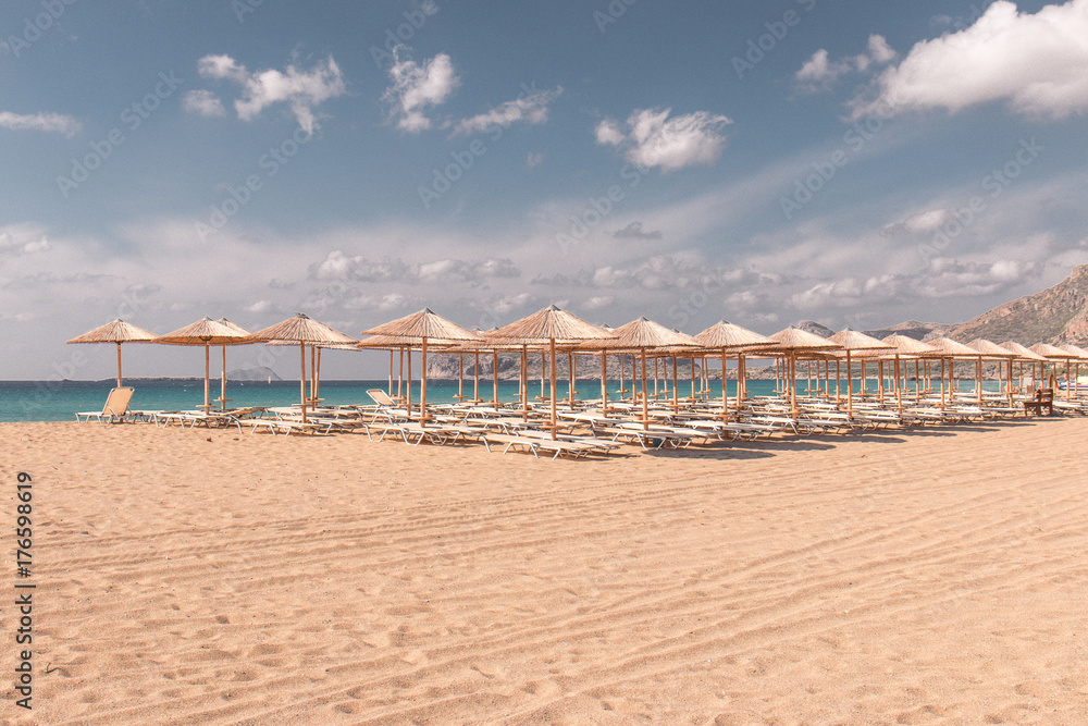 Beach sunbeds and parasols overlooking turquoise water