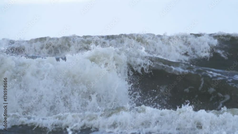 Stormy seas during bad weather cyclone hurricane Winds. Slow motion sea ocean water big surf wave splash beach. Stormy seas during bad weather cyclone hurricane Winds. Slow motion sea ocean water big surf wave splash beach.