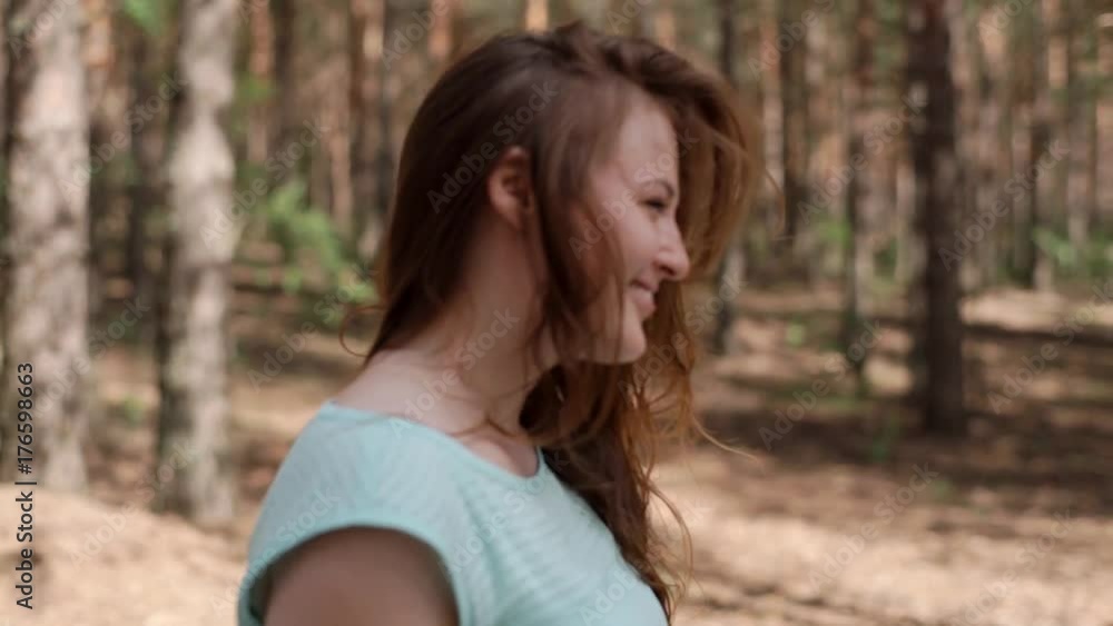 A happy girl is walking in the forest. A happy girl is walking in the forest.