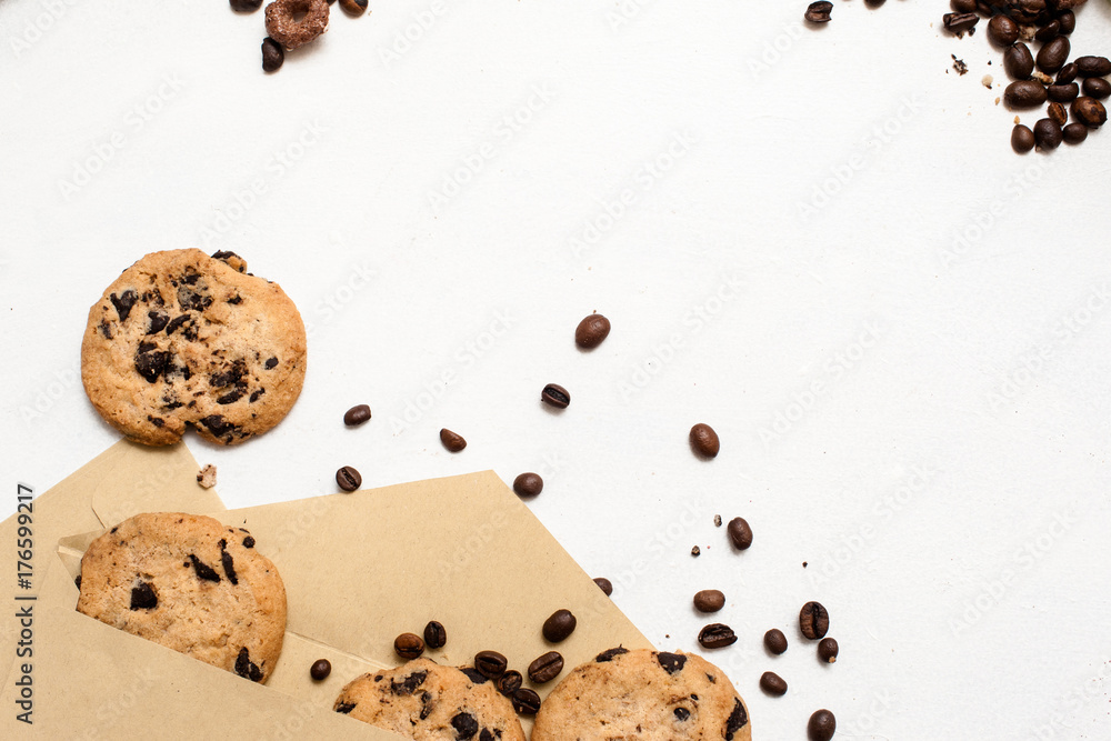 Fond of sweets and bakery shops concept. Small elegant presents with home-baked chocolate scones and coffee seeds decoration on white background, top view with free space Fond of sweets and bakery shops concept. Small elegant presents with home-baked chocolate scones and coffee seeds decoration on white background, top view with free space