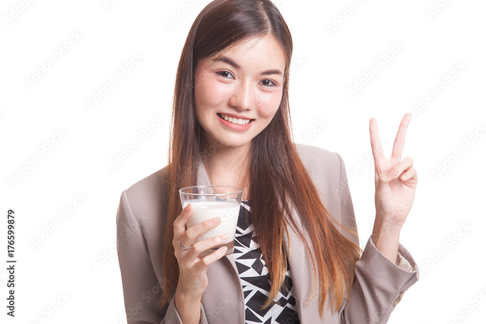 Healthy Asian woman drinking a glass of milk show victory sign. Healthy Asian woman drinking a glass of milk show victory sign.
