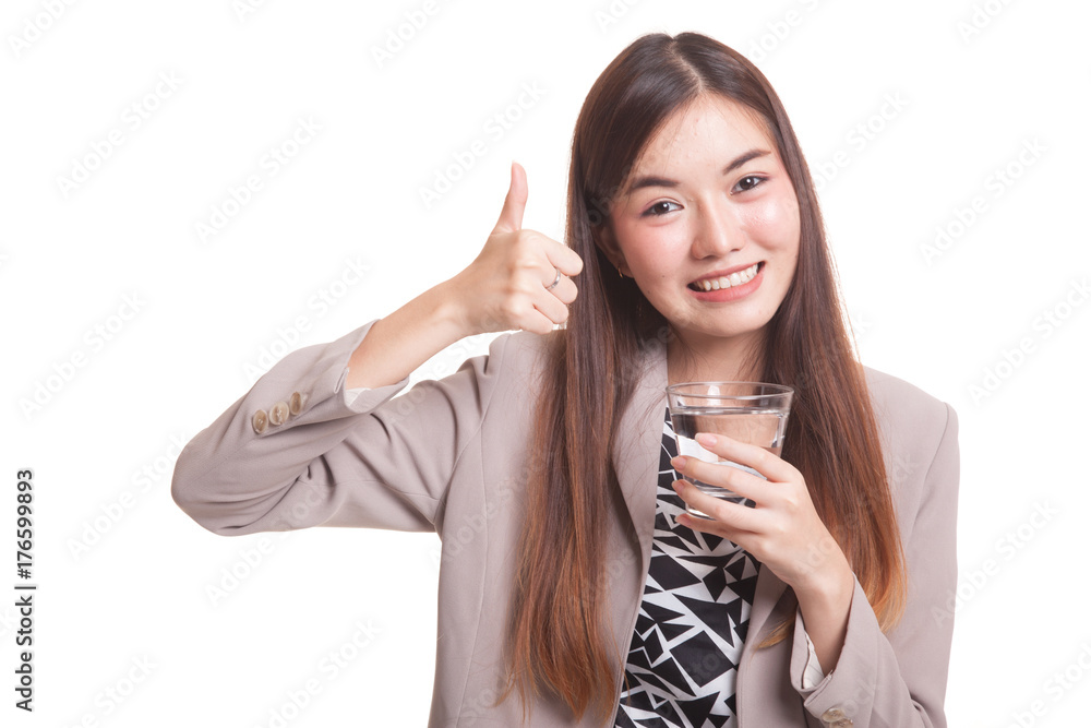 Young Asian woman thumbs up with a glass of drinking water. Young Asian woman thumbs up with a glass of drinking water.