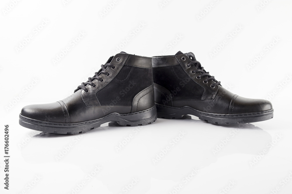 Male black leather boot on white background, isolated product. Male black leather boot on white background, isolated product.