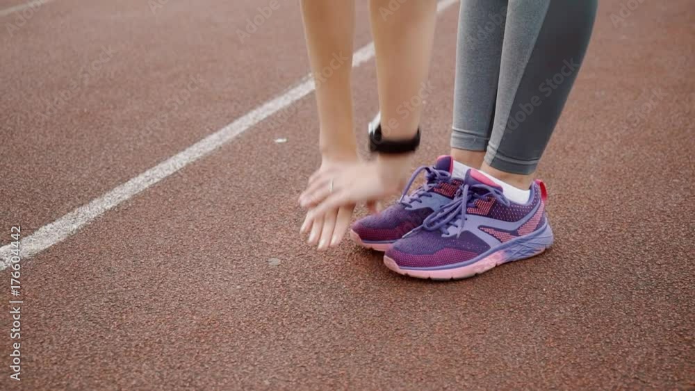 Sportswoman warm up at sport stadium before running competition Sportswoman warm up at sport stadium before running competition