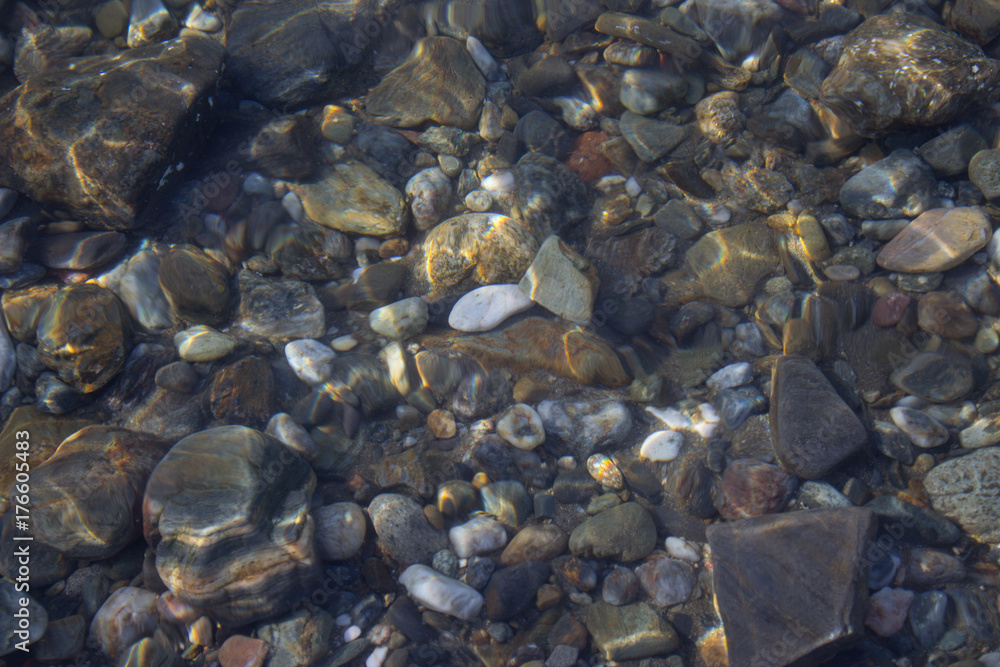 The seabed of colored pebbles near the shore