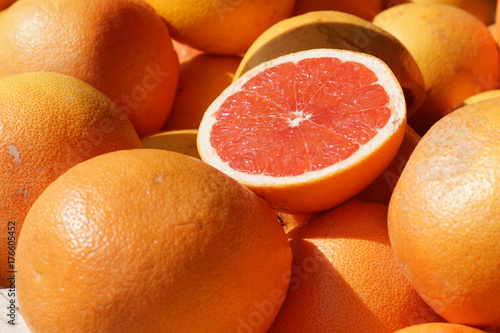 Ripe half of the grapefruit is on the counter at the fruit market in Spain