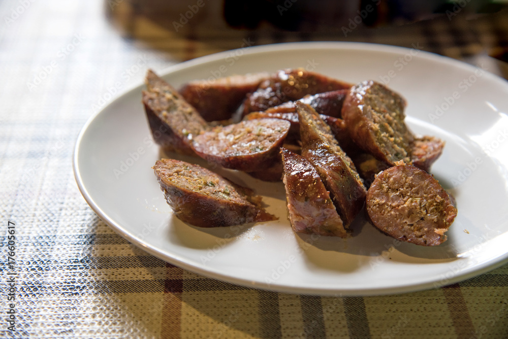 Sai Aua or Northern Thai traditional sausage grill sliced on white plate,Thai spicy sausage, selective focus
Sai Aua or Northern Thai traditional sausage grill sliced on white plate,Thai spicy sausage, selective focus
