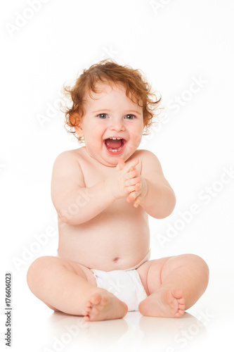 Happy baby boy is sitting on white background