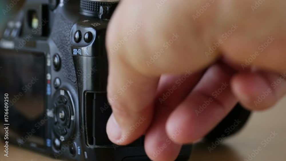 Inserting a memory card into camera slot. Inserting a memory card into camera slot.