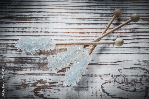 Sweet sugar sticks on vintage wooden board