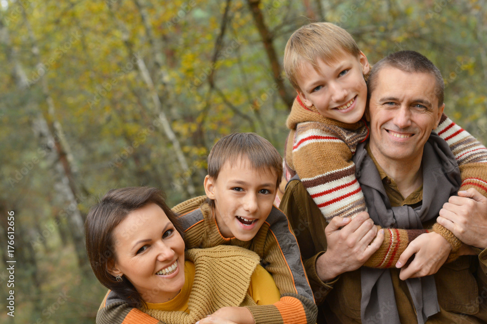 Fototapeta premium smiling family in autumn forest 