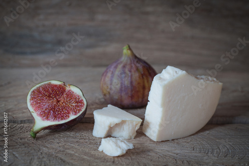 goat cheese with figs on a wooden background
