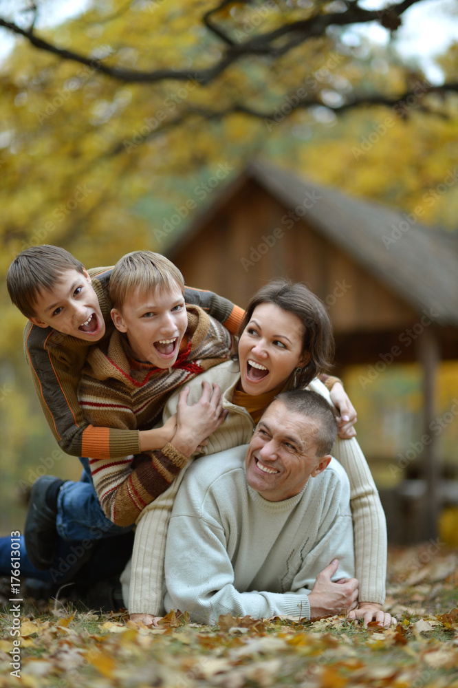 family having fun   in autumn forest 