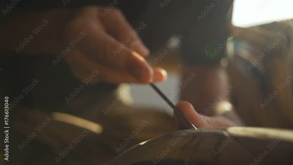 Close up woodcarving in sun glare rapid slow motion Close up woodcarving in sun glare rapid slow motion