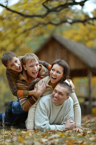 family having fun in autumn forest 
