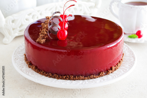 Chocolate cherry cake covered with a mirror coating. photo