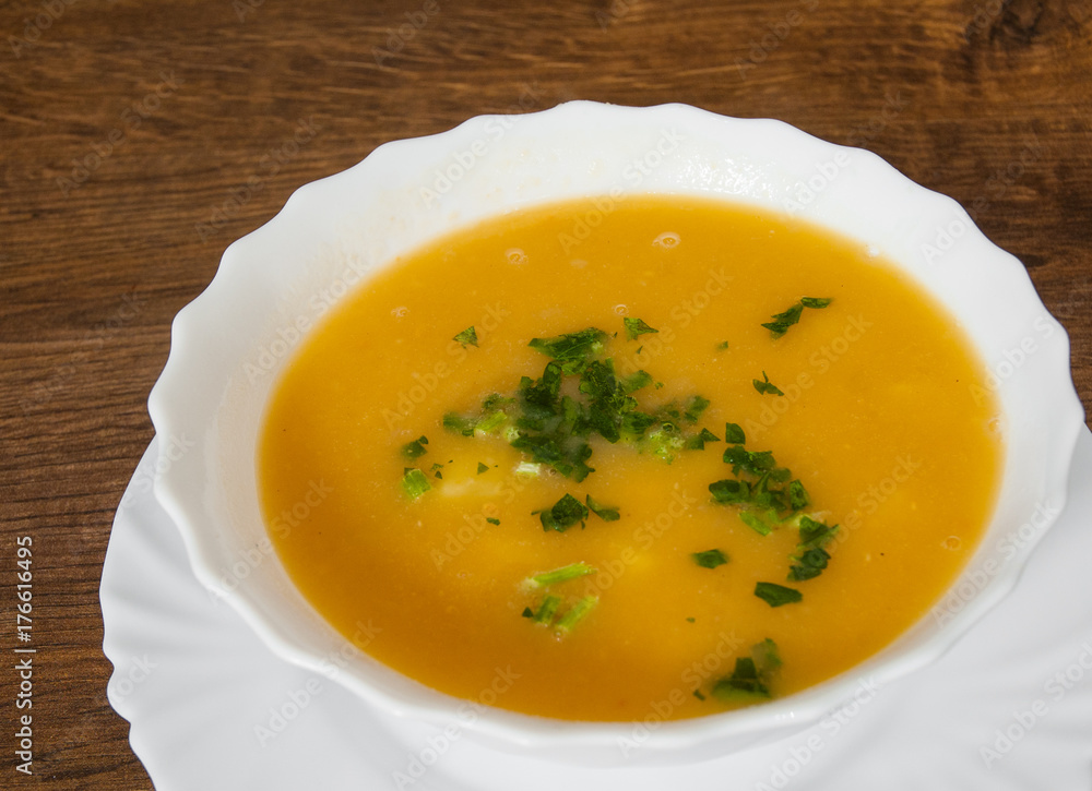 Vegetarian cream pea soup on a wooden background. Vegetarian cream pea soup on a wooden background.