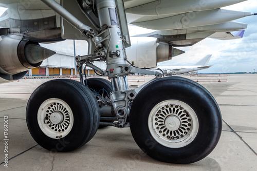 close up of airplane wheel parked at the airport