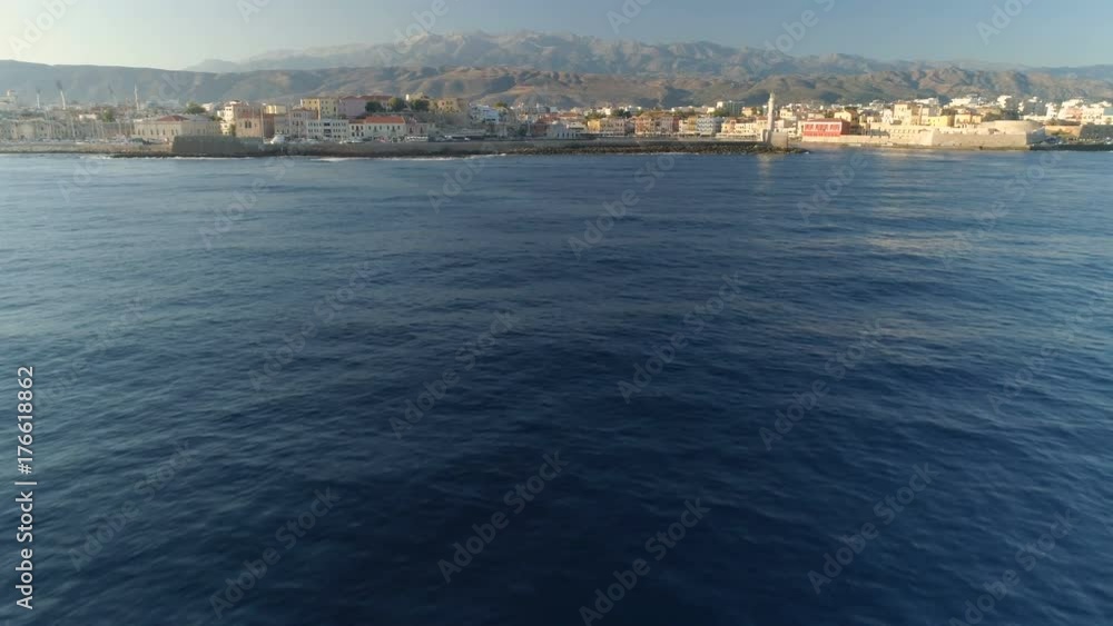 Flying low above the ocean to reveal Old Town of Chania in Crete, Greece Flying low above the ocean to reveal Old Town of Chania in Crete, Greece