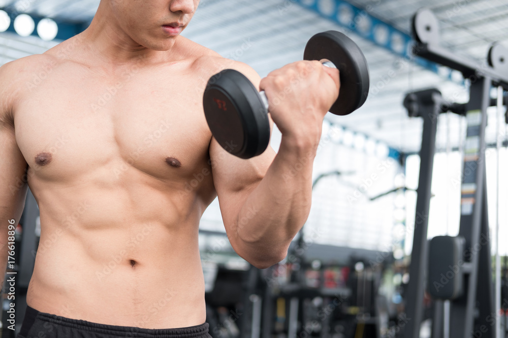 man lift dumbbell in gym. bodybuilder male working out in fitness center. sport guy doing exercises in health club. man lift dumbbell in gym. bodybuilder male working out in fitness center. sport guy doing exercises in health club.