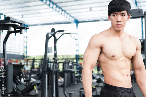 man athlete prepare for training in gym. bodybuilder male working out in fitness center. sport guy doing exercises in health club.