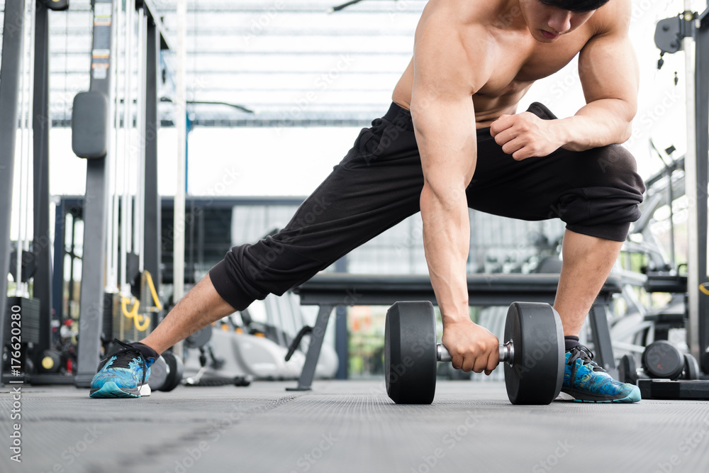 man lift dumbbell in gym. bodybuilder male working out in fitness center. sport guy doing exercises in health club. man lift dumbbell in gym. bodybuilder male working out in fitness center. sport guy doing exercises in health club.