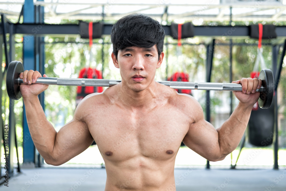 muscular man execute exercise in fitness center. male athlete pump up muscle in gym. weightlifter working out with barbell in health club. muscular man execute exercise in fitness center. male athlete pump up muscle in gym. weightlifter working out with barbell in health club.