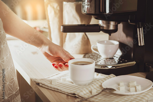 Obraz na płótnie Woman making fresh espresso in coffee maker