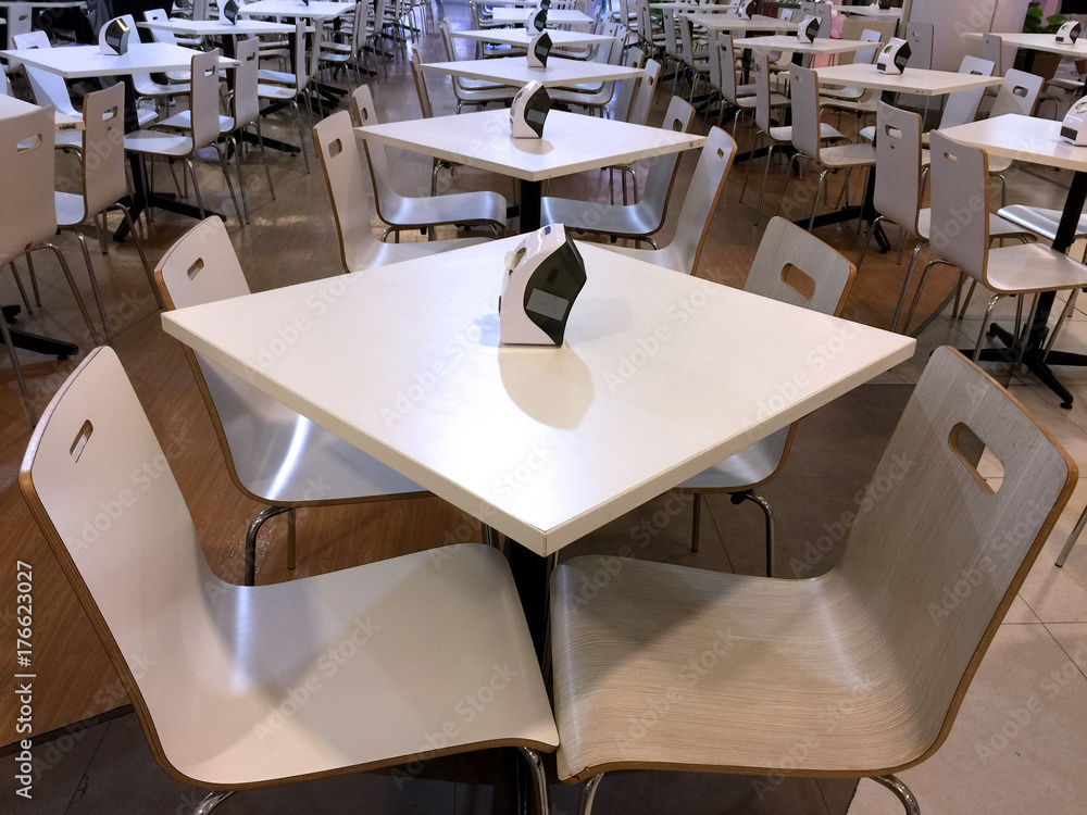 Tables and Chairs Line Up in a Cafeteria Tables and Chairs Line Up in a Cafeteria