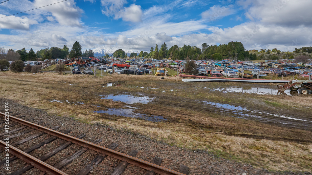 Automobile scrap yard beside a railway track