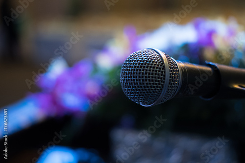 microphone in modern conference hall interior with white chairs. seminar room with empty seat. business event