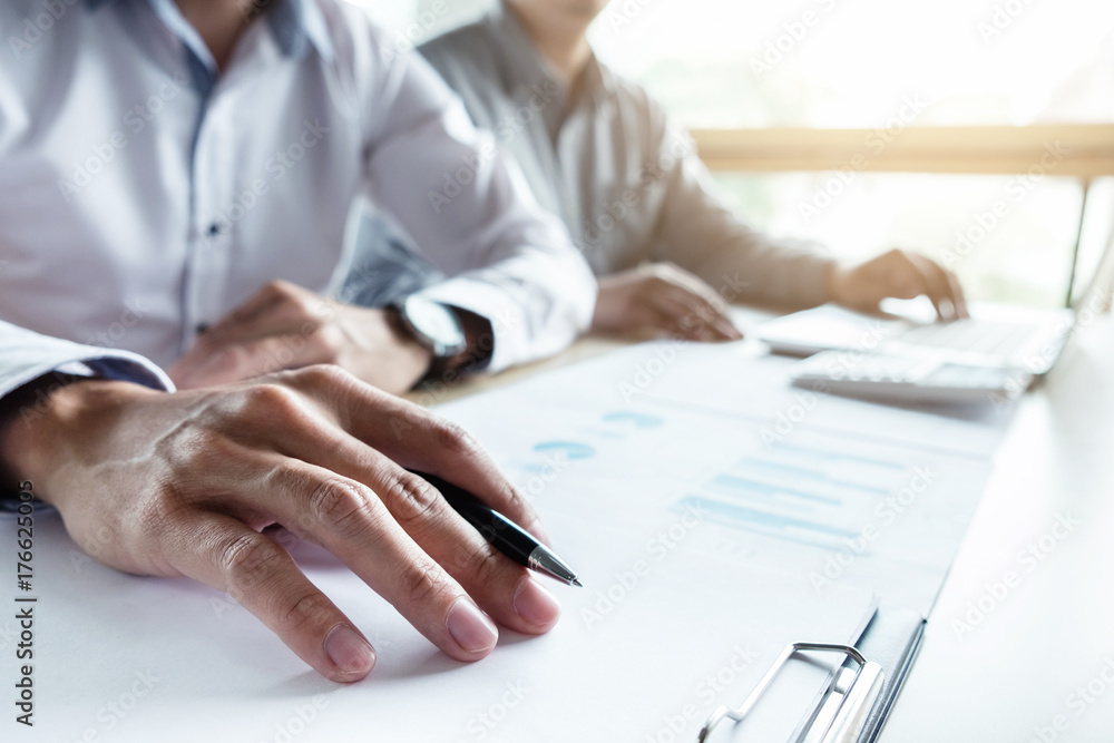 Man sign a home insurance policy on home loans, Agent holds loan investment chart graph documents and calculating table installment payment, Real Estate concept Man sign a home insurance policy on home loans, Agent holds loan investment chart graph documents and calculating table installment payment, Real Estate concept