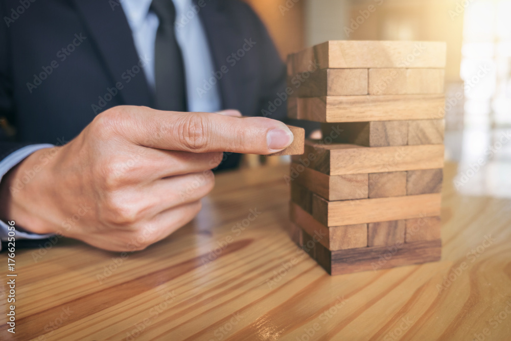 Alternative risk concept, plan and strategy in business, Risk To Make Buiness Growth Concept With Wooden Blocks, Images of hand of businesspeople placing and pulling wood block on the tower Alternative risk concept, plan and strategy in business, Risk To Make Buiness Growth Concept With Wooden Blocks, Images of hand of businesspeople placing and pulling wood block on the tower