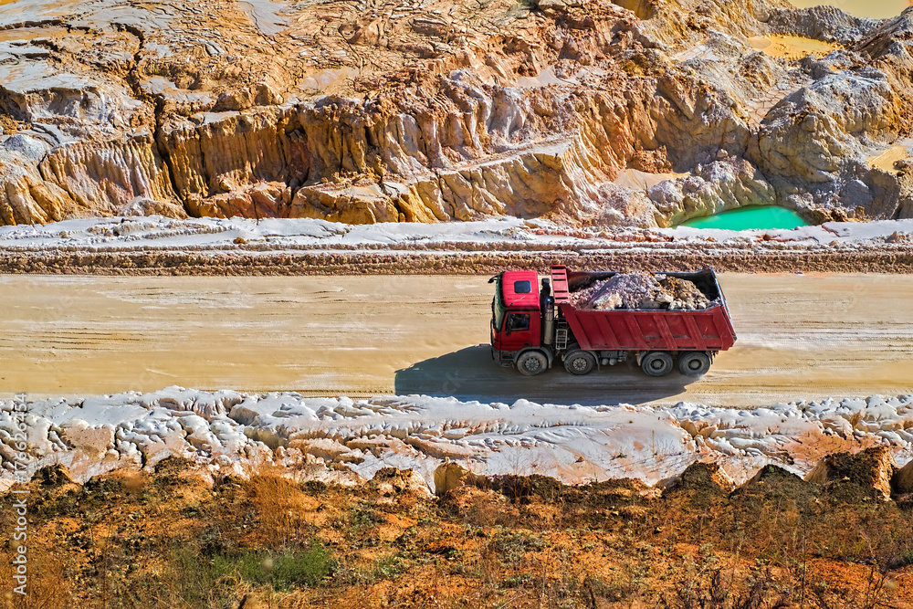 Fototapeta premium The red dump truck. Kaolin quarry. Vetovo village area, Bulgaria.