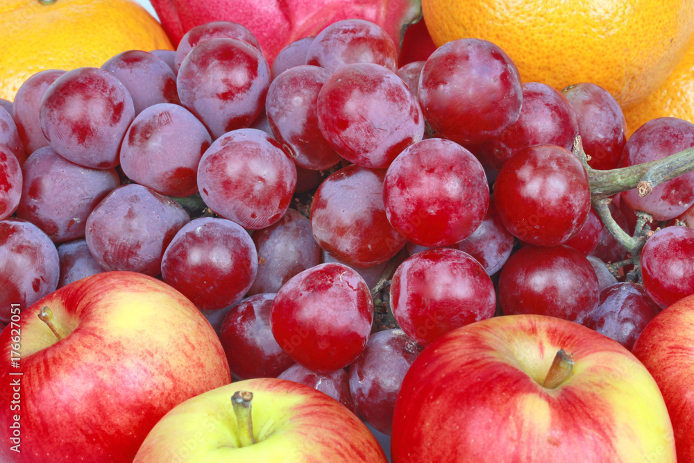 Mixed fruits as Red seedless grapes,orange,apple,Dragon fruit,Japanese golden melon. Mixed fruits as Red seedless grapes,orange,apple,Dragon fruit,Japanese golden melon.
