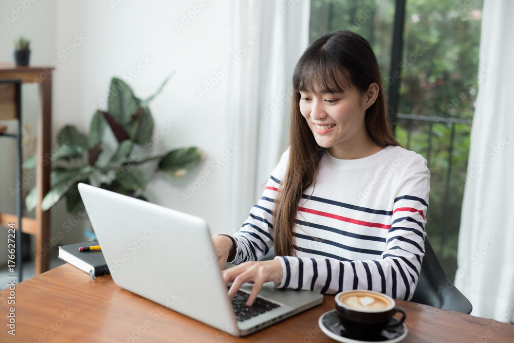New generation asians business woman using laptop at coffee shop,Asian women sitting smiling while working on mobile office concept New generation asians business woman using laptop at coffee shop,Asian women sitting smiling while working on mobile office concept