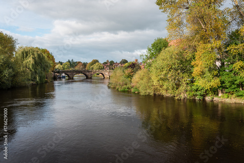 View along the river Severn towards the Welsh bridge with autumn colours, Shrewsbury, Shropshire, UK.