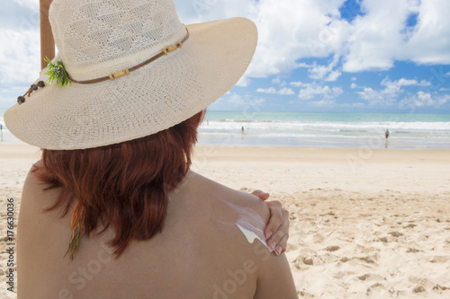 Woman holding a mobile on the beach
