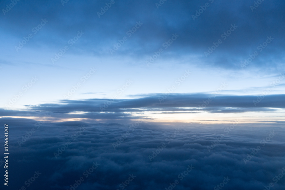 Sunrise above clouds seen through airplane window