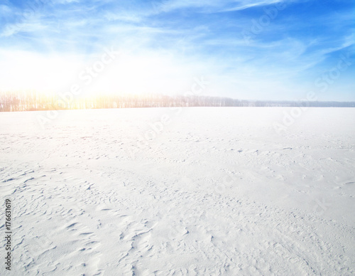  Snowcovered fields on blue sky © Alekss