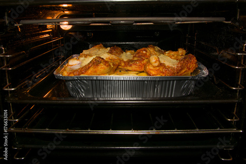 home cooking potatos with chicken in oven. Selective focus