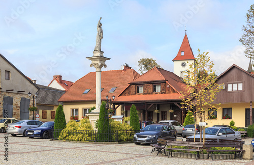 Lipnica Murowana, Poland. Market Square with St. Szymon of Lipnica Column and historic buildings photo