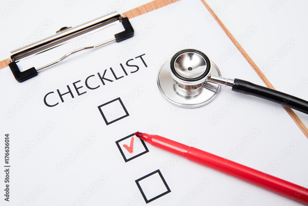 Checklist on white paper with stethoscope Checklist on white paper with stethoscope