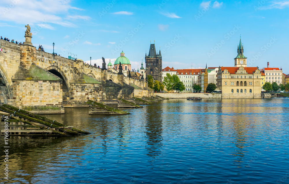 Charles Bridge in Prague in the Czech Republic. Old Town Bridge Tower. The Mill peninsula. Sculptures on the Charles Bridge.  The Vltava River