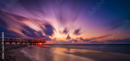 Sunset over wooden pier panorama